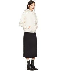White hoodie with black midi skirt and heeled leather boots