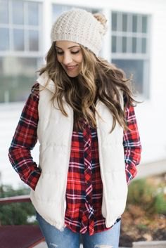 white knit hat with red and black plaid shirt and light blue jeans