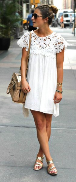 White pleated swing mini dress with lace cap sleeves and gold strappy sandals