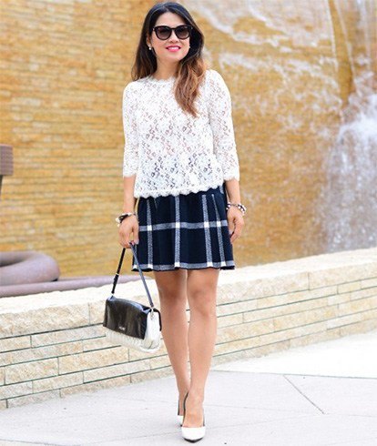 White lace blouse with scalloped hem and black checked skirt