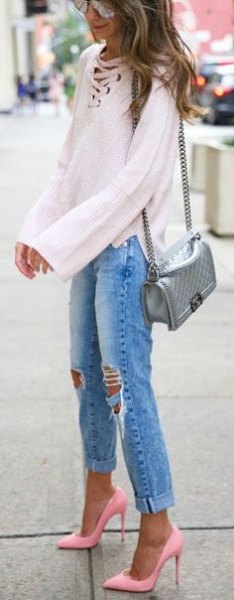 White long sleeve blouse with a lace up neckline, boyfriend jeans and light pink heels