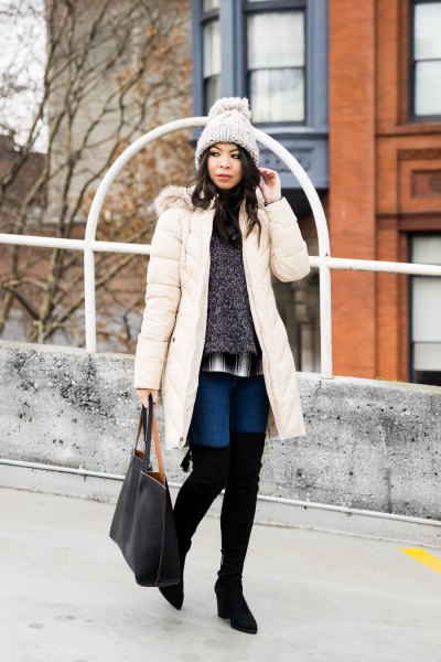 long white down coat with mottled gray sweater and thigh high boots
