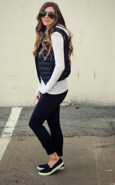 White long-sleeved T-shirt with a short, black quilted vest with a
hood