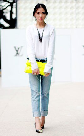 White long sleeve t-shirt with light blue cuffed jeans and yellow clutch