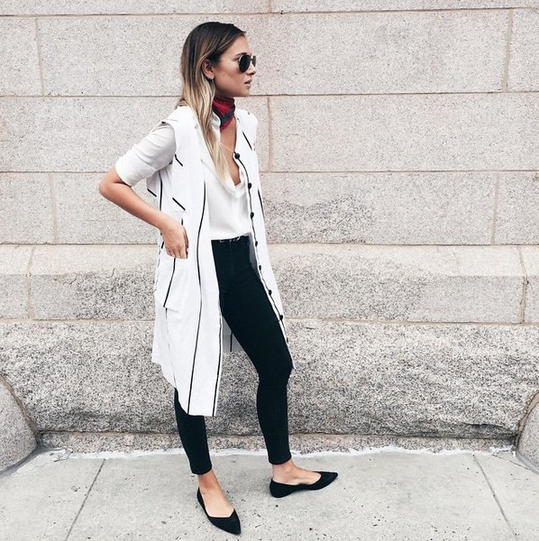 white longline vest with a long-cut blouse and black pointed ballerinas