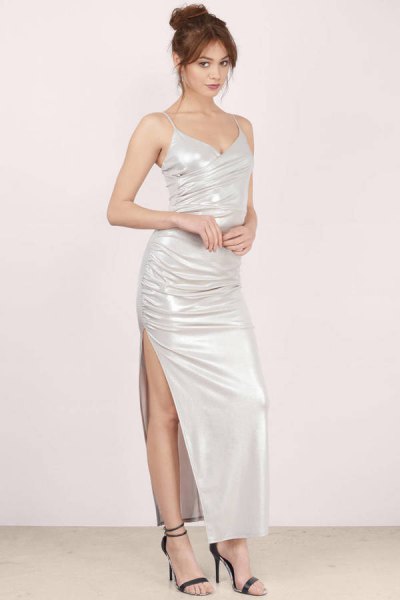 White bodycon maxi dress with a high slit and open toe heels
