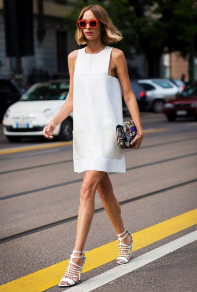 White sleeveless mini shift dress with matching strappy open toe heels