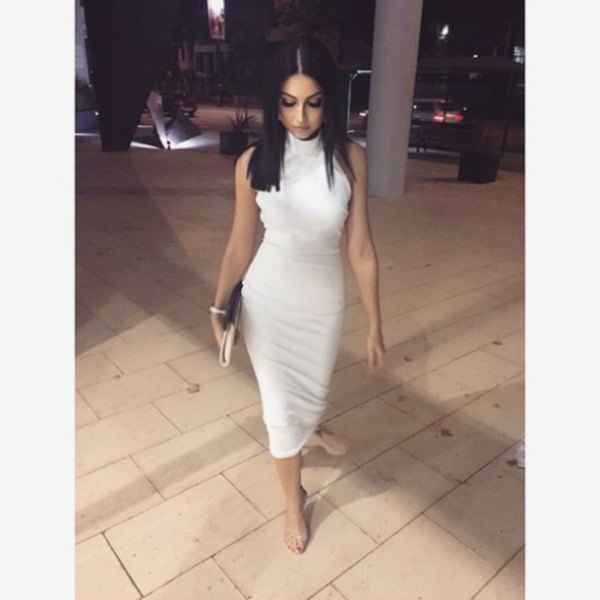 White sleeveless bodycon midi dress with a high neck and open heels