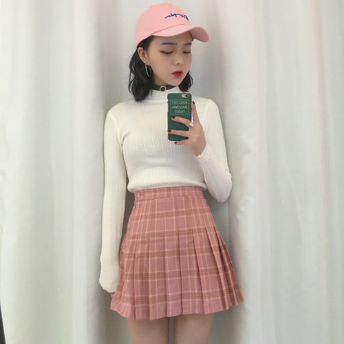 White high neck sweater with pink high waisted pleated mini skirt