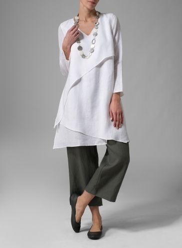 White layered tunic top with gray wide leg pants