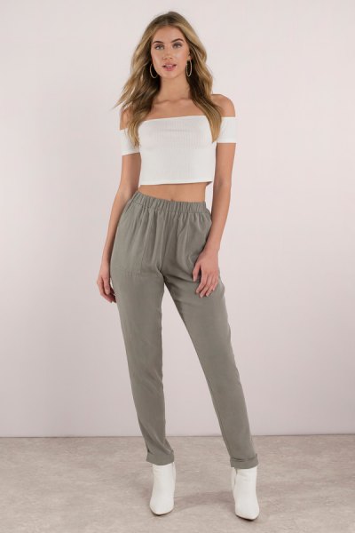 White off shoulder crop top paired with green khaki pants with elastic waistband