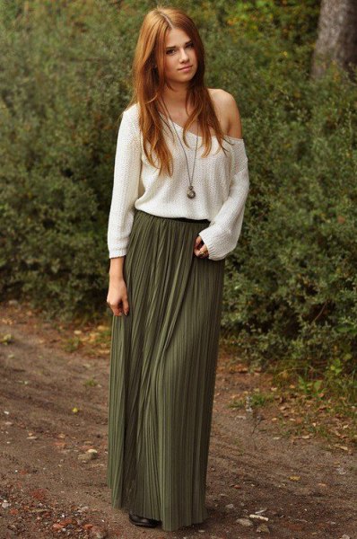 White one-shoulder sweater with a floor-length pleated skirt
