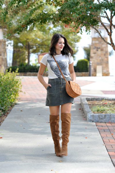 White printed t-shirt with gray corduroy mini skirt and thigh high boots