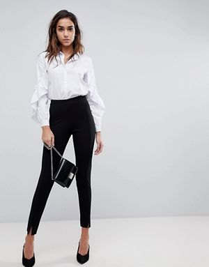 White button down shirt with puff sleeves and black high rise chinos