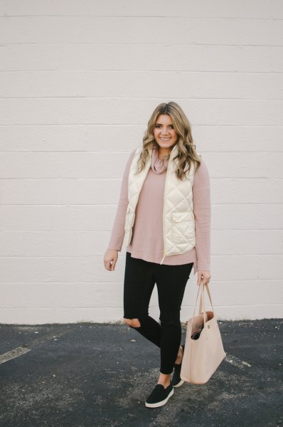 white quilted down vest with light gray sweater and black jeans