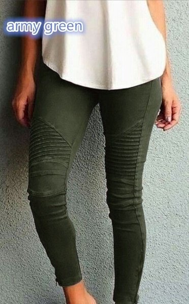 White relaxed tank top paired with dark green pleated skinny jeans
