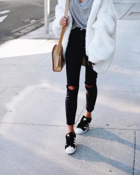White ribbed chunky cardigan sweater with gray oversized t-shirt and black jeans