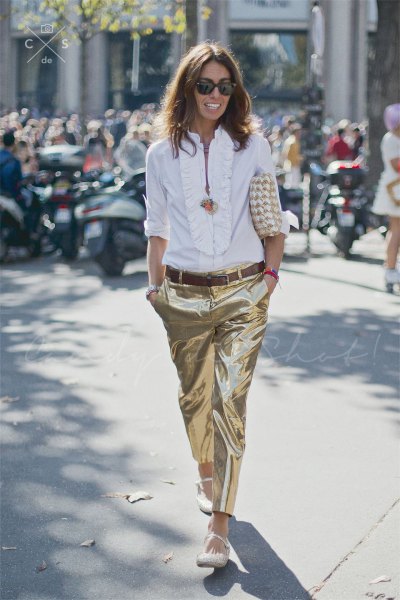 White blouse with a ruffle neckline and gold metallic pants