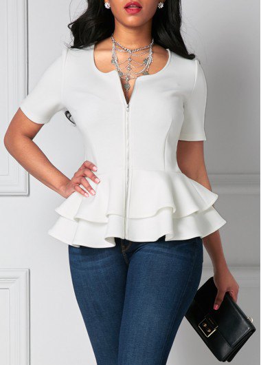 White, short-sleeved, fitted peplum blouse with dark blue skinny jeans