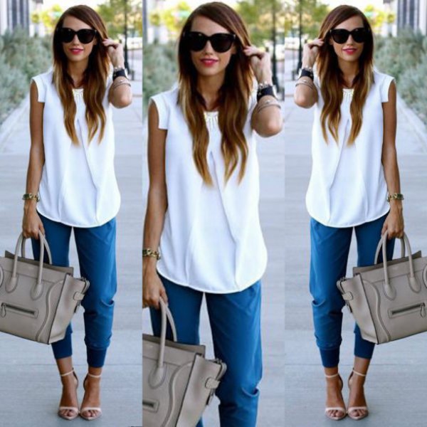 White sleeveless chiffon blouse with blue tapered trousers