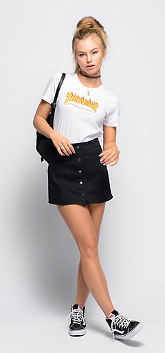 White slim fitting tucked in t-shirt with black mini mini skirt with button front closure