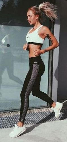 White sports bra top with black and gray running tights and sneakers