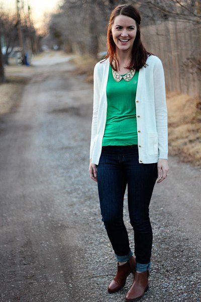 White cardigan with green scoop neck blouse and ankle jeans