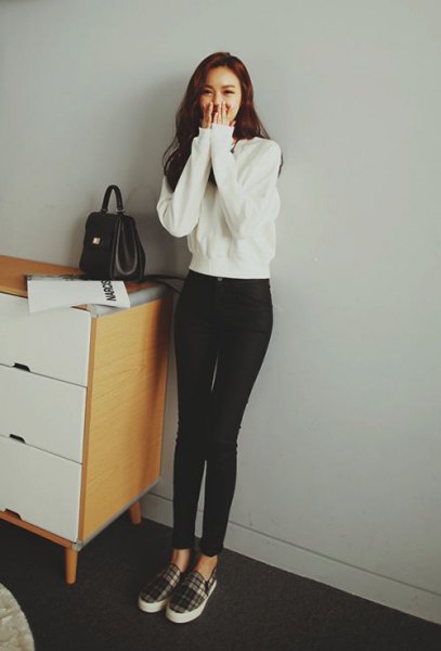 White sweater with black high waisted skinny jeans and plaid canvas
shoes