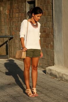 White jumper with a boho-style statement necklace and heeled sandals