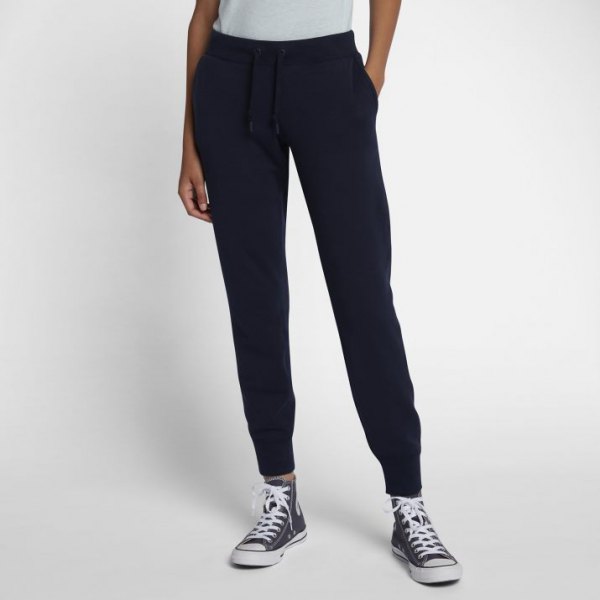 White t-shirt with black fleece pants with a tapered leg and high-top sneakers