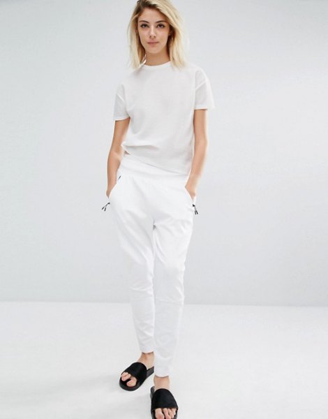White t-shirt with matching pants and black slide sandals