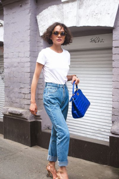 White t-shirt with mom jeans and royal blue leather handbag