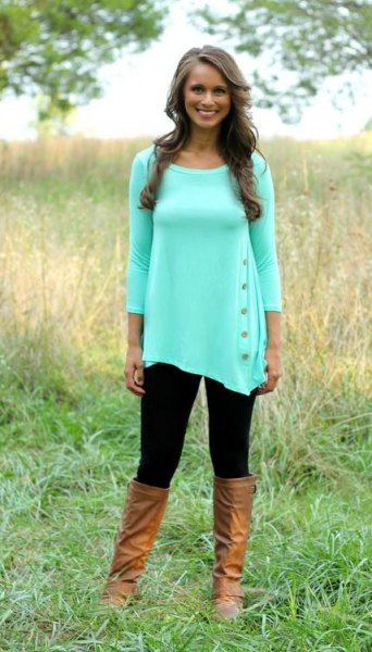 White tunic blouse with three quarter sleeves and knee high leather boots