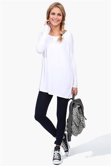 White tunic long sleeve t-shirt with black ankle jeans