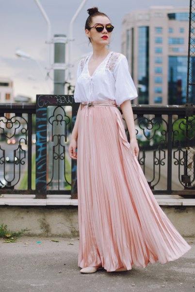 White short-sleeved V-neck blouse with pale pink flowy skirt