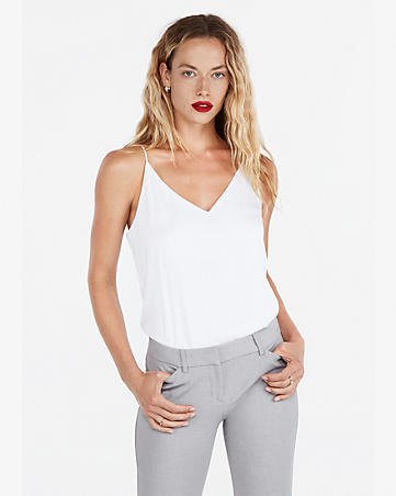 White V-neck tank top and gray slim-fit jeans