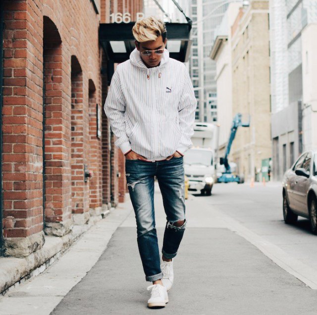 White windbreaker with blue washed cuffed straight leg jeans