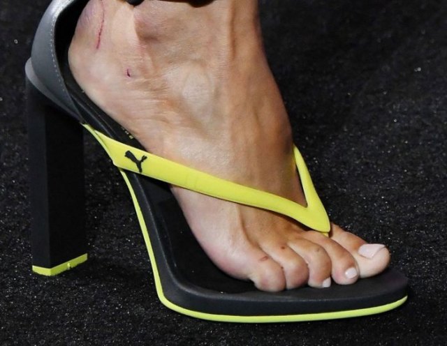 Yellow and black high heel flip flops from the sports brand paired with jogging bottoms