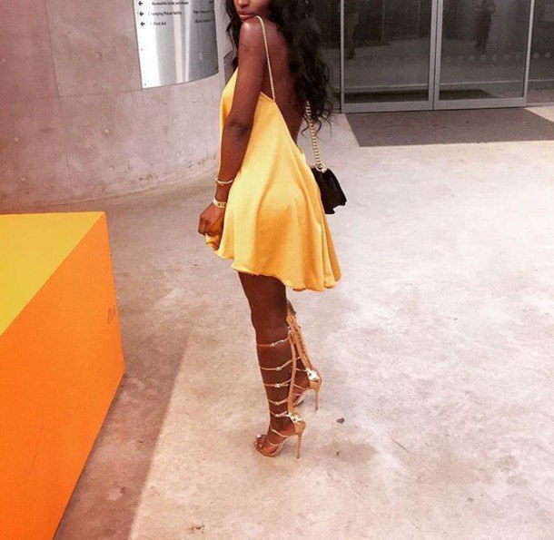 Yellow backless skater dress with matching lace-up heels