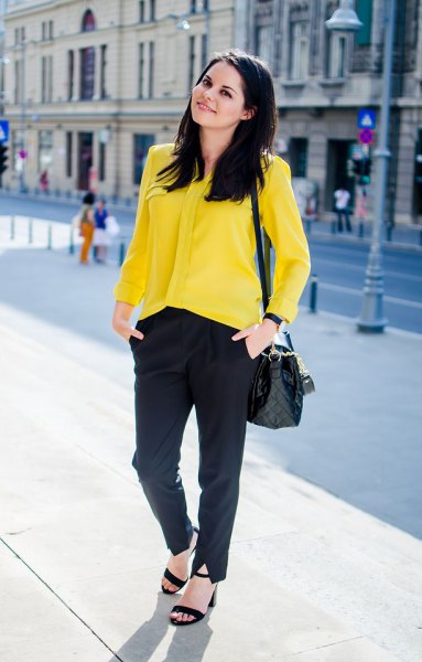yellow button down shirt, black chinos and heeled sandals