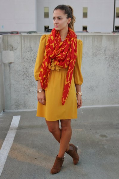Yellow fit and flare mini dress with orange and gold scarf