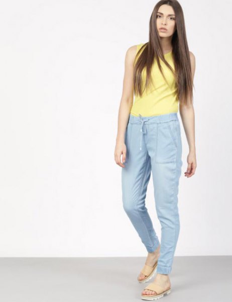 yellow sleeveless top with blue high waist sweatpants