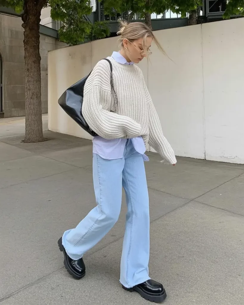 Slouchy knit layered over white shirt with light denim