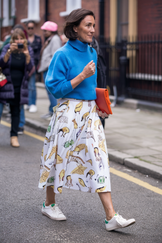 Blue sweater with animal print skirt and white sneakers