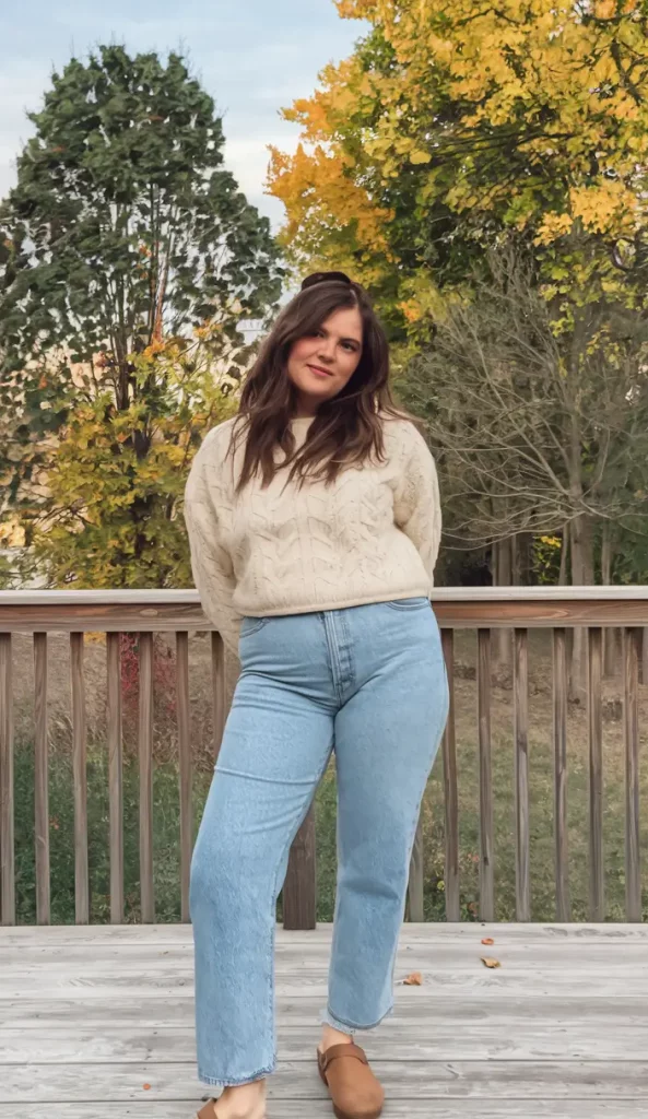 Cable knit sweater with jeans and clogs