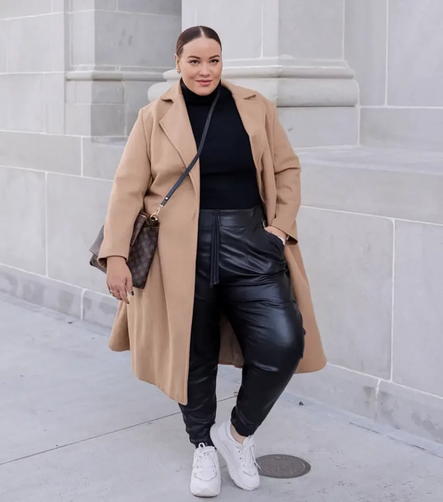 Black turtleneck and faux leather pants with camel coat